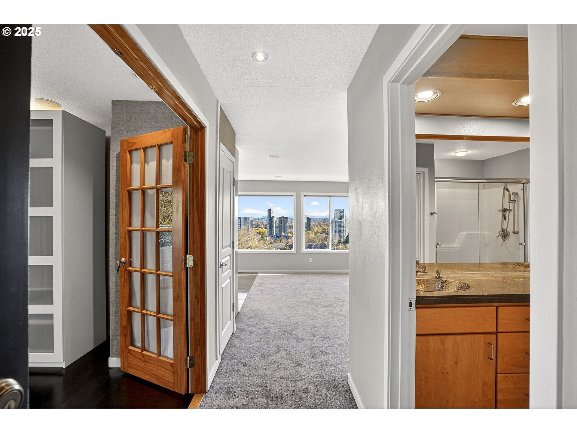 3515 Southwest Barbur Boulevard, Unit R2 Portland, OR 97239 - Photo 6 of 35 a bathroom with a tub shower and mirror