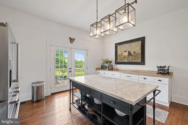 a view of a house with pool and sitting area