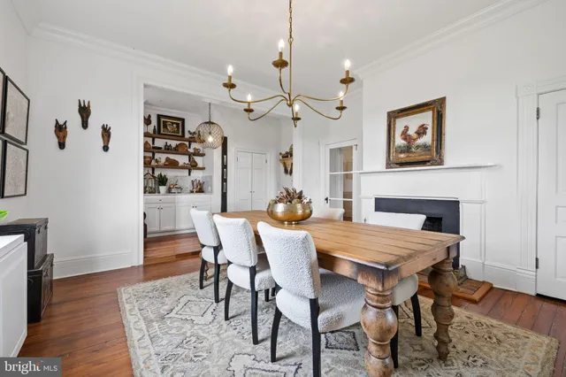 a view of a white house with a big yard and large trees