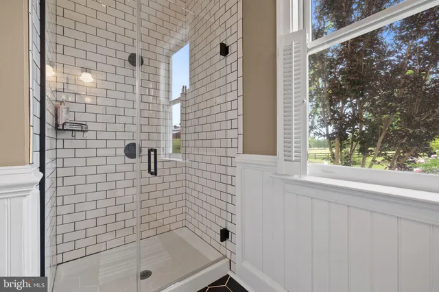 a view of a dining room with furniture large windows and wooden floor