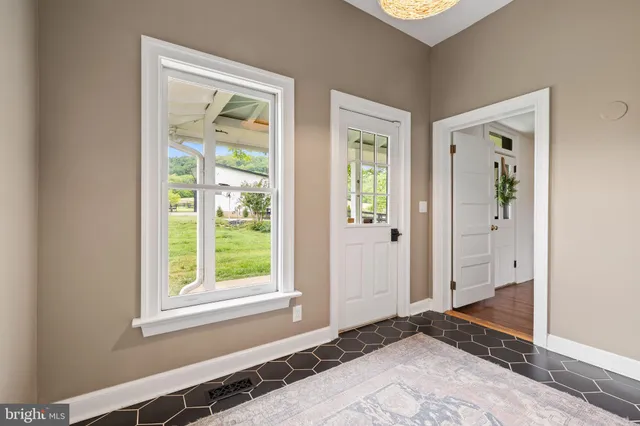 a bed room with a bed and a large window