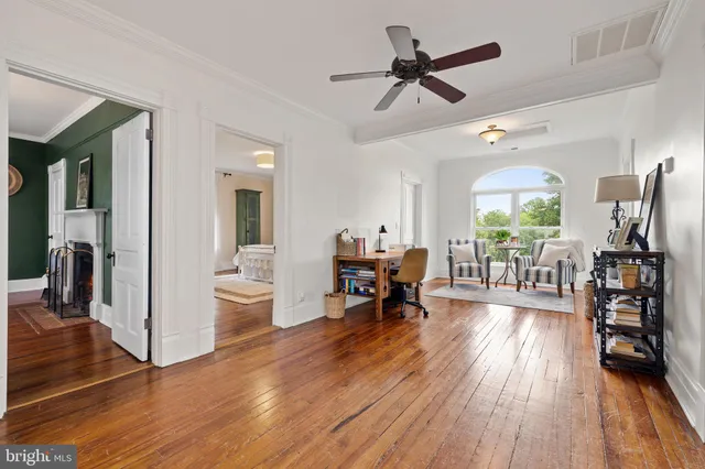 a front view of house with yard and trees in the background