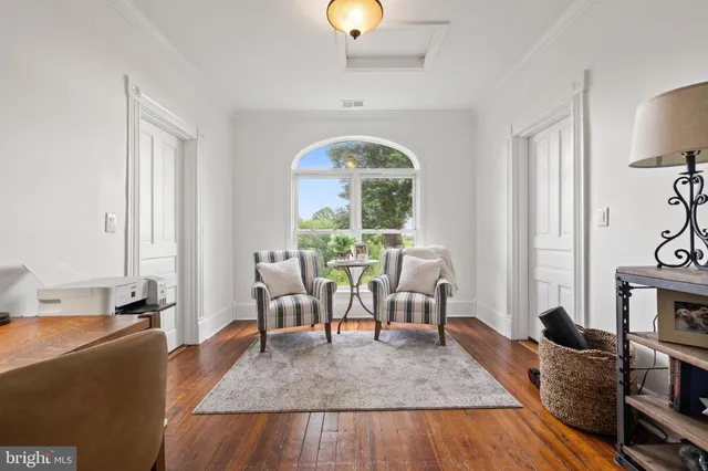 a view of a house with a yard and potted plants