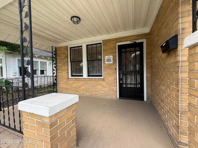 a view of a porch with a table and chairs