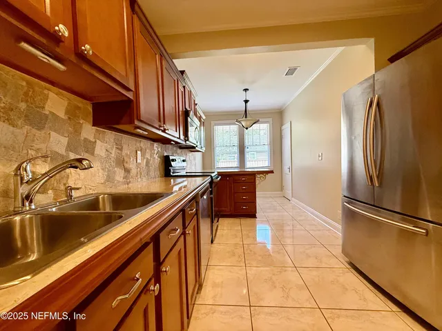 a kitchen with stainless steel appliances granite countertop a refrigerator and a sink