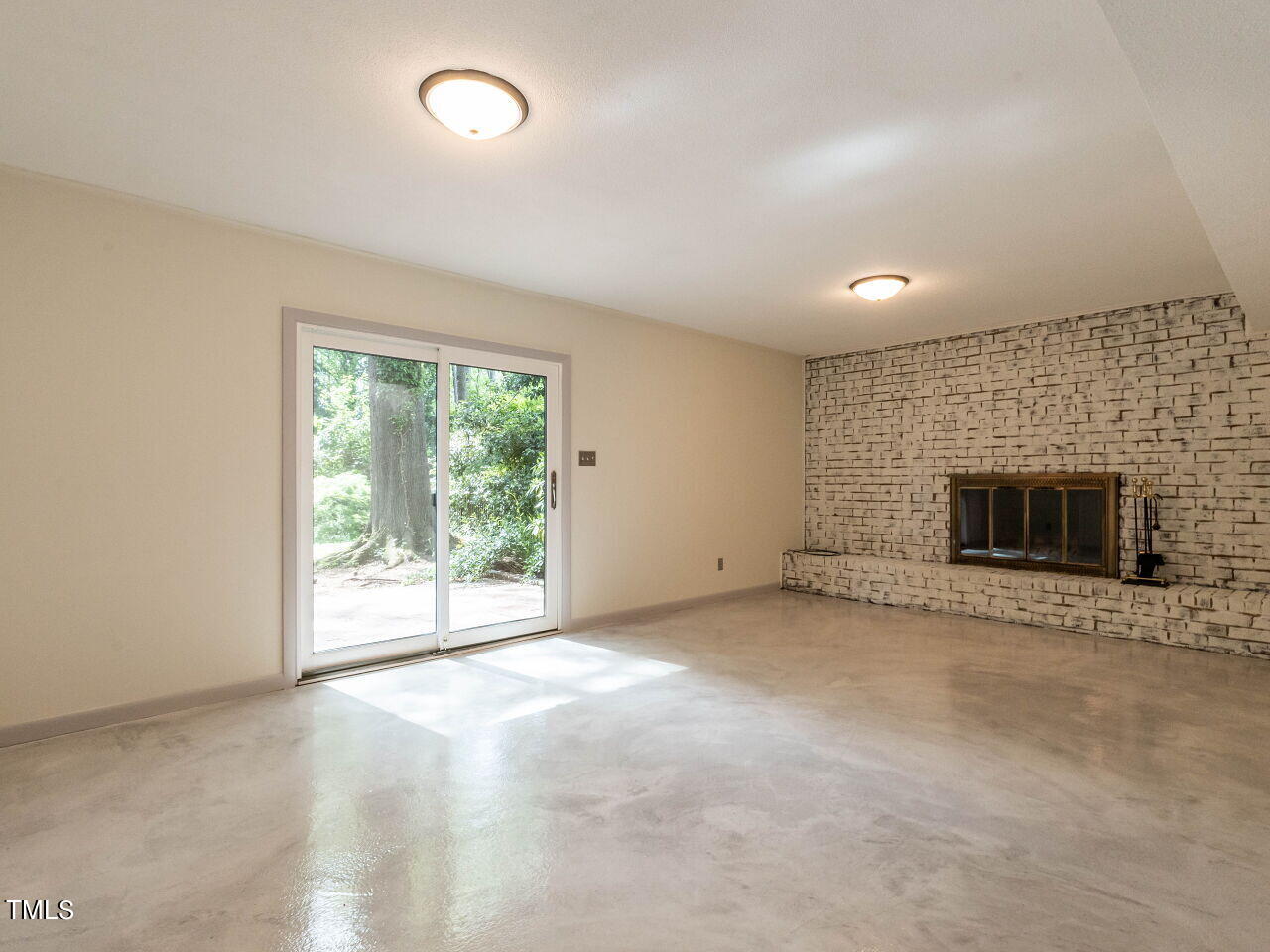 2204 Myron Drive Raleigh, NC 27607 - Photo 25 of 57 Lower level family room leads to back yard brick patio through replacement slider doors.