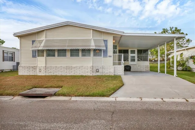 a front view of a house with swimming pool and porch