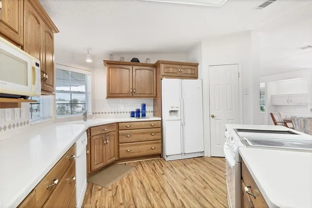 a kitchen with granite countertop a sink and a refrigerator
