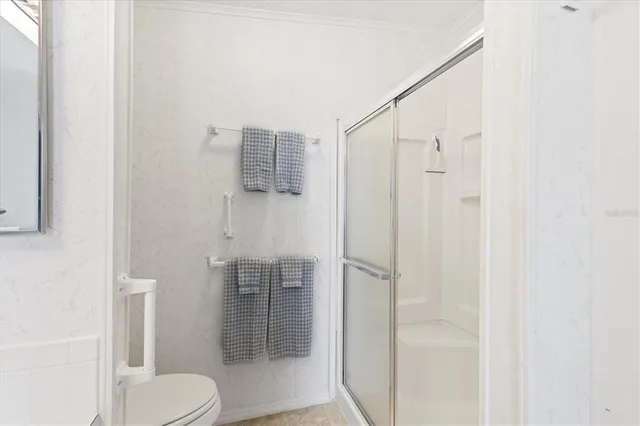 a bathroom with a shower and toilet