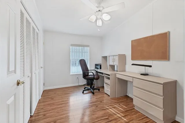 a view of a workspace with furniture and a window