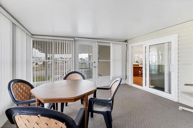 a dining room with furniture a rug and wooden floor