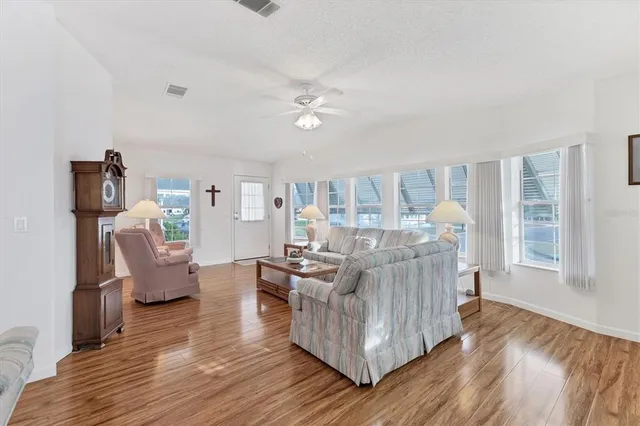 a living room with furniture and wooden floor