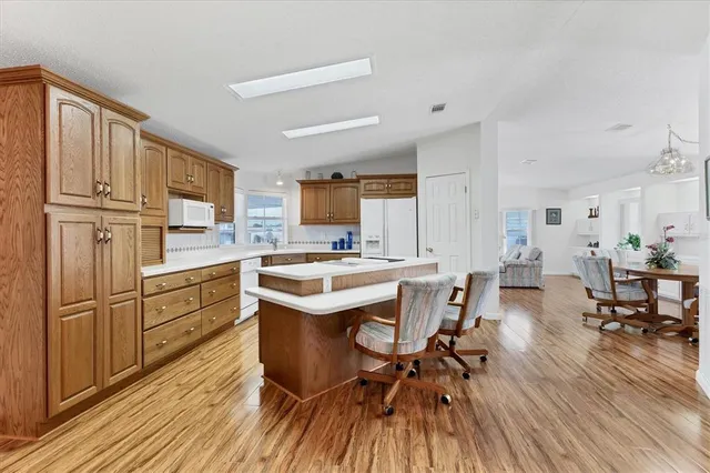 a kitchen with a table chairs refrigerator and cabinets