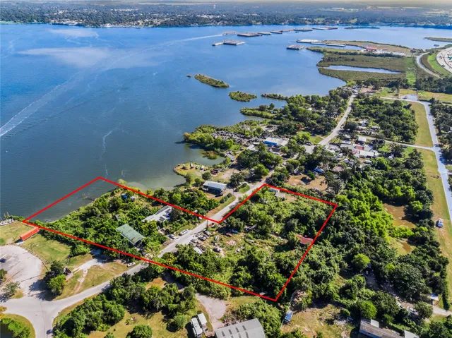 an aerial view of a residential houses with outdoor space