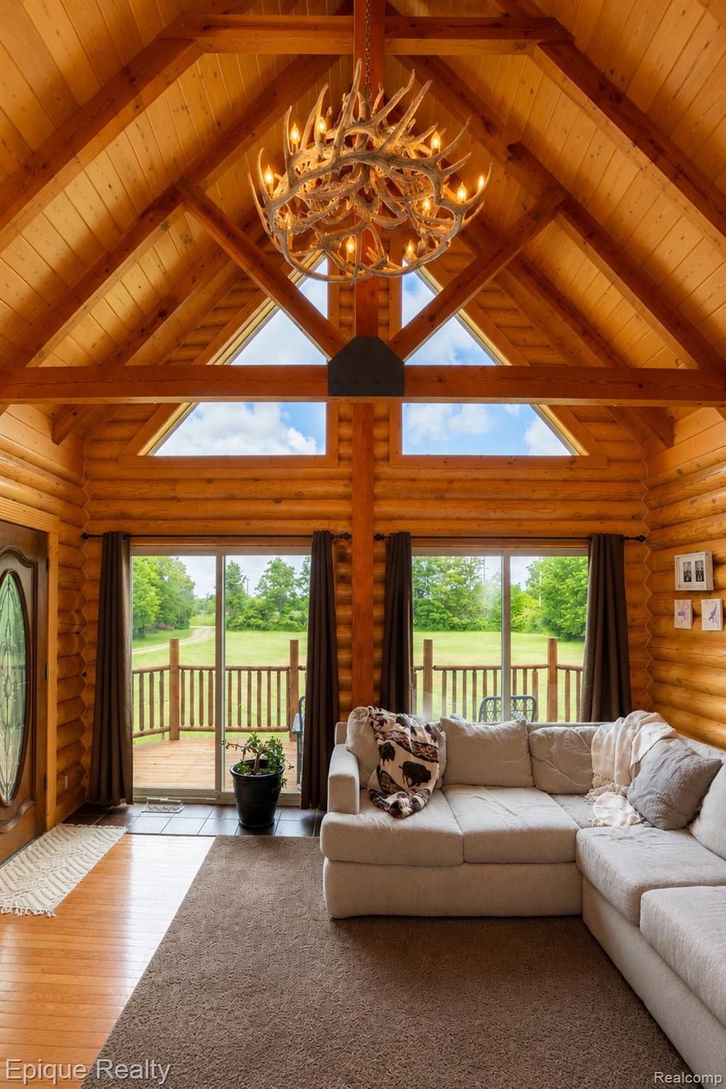 1966 Mayer Road Smiths Creek, MI 48074 - Photo 19 of 38 Vaulted ceiling with exposed wood beams and a multi-tiered antler chandelier