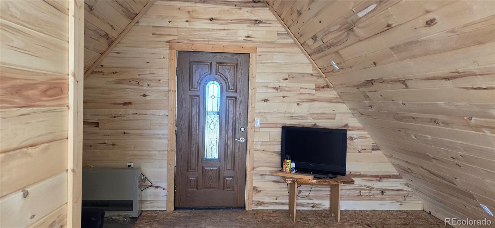 101 MacArthur Road Fort Garland, CO 81133 - Photo 5 of 21 a view of a fireplace with wooden door