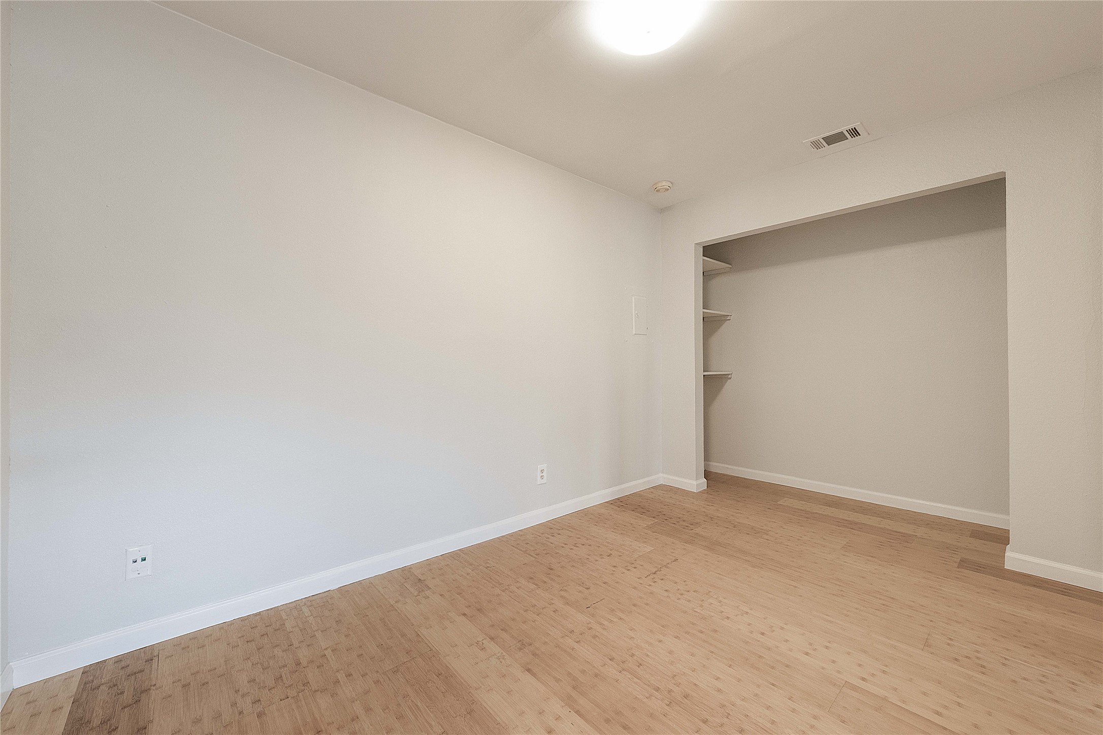 2500 Burleson Road, Unit 512 Austin, TX 78741 - Photo 11 of 16 Unfurnished bedroom featuring a closet and light wood finished floors