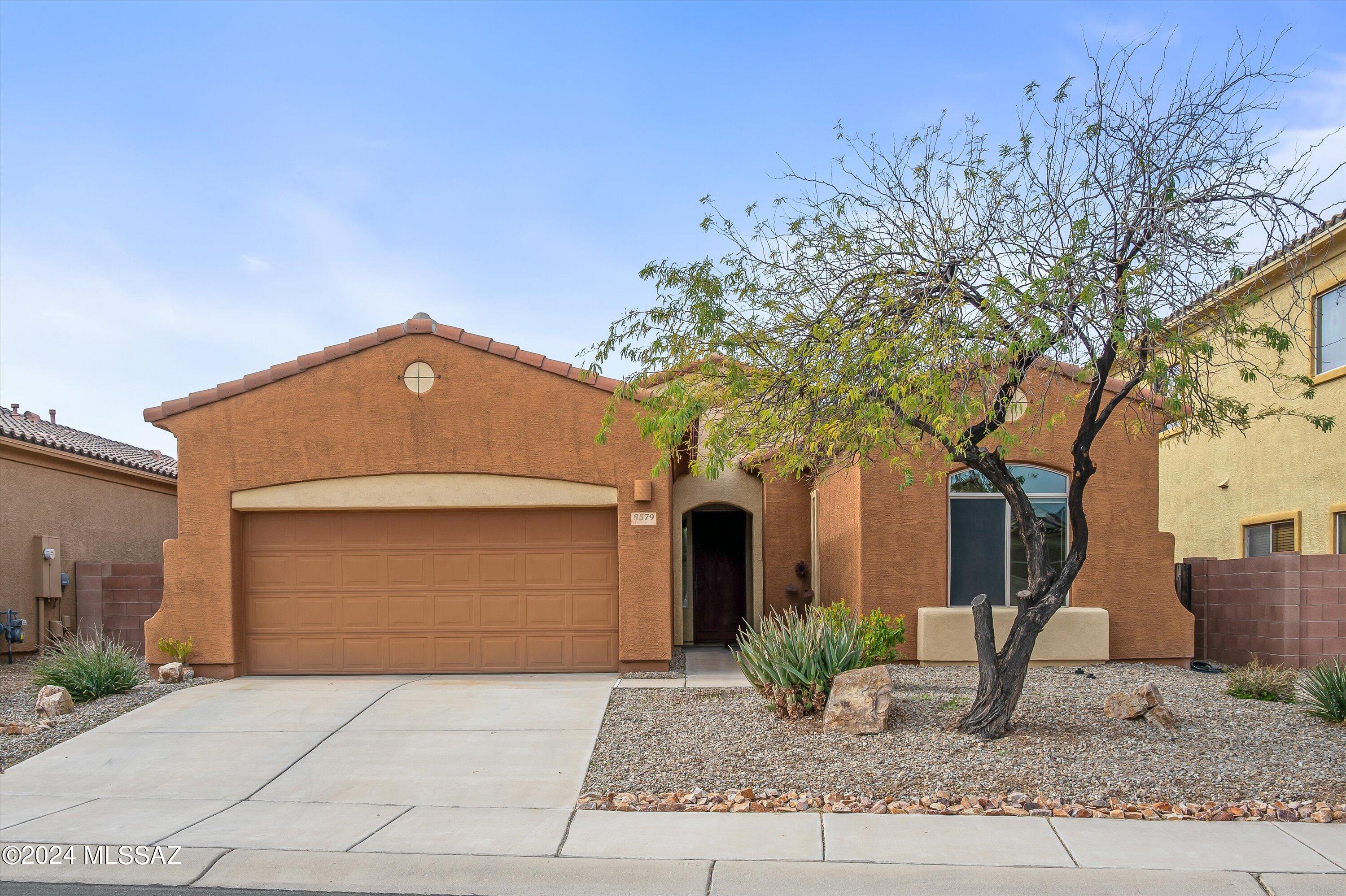 8579 North Shadow Wash Way Tucson, AZ 85743 - Photo 2 of 34 a front view of a house with garden