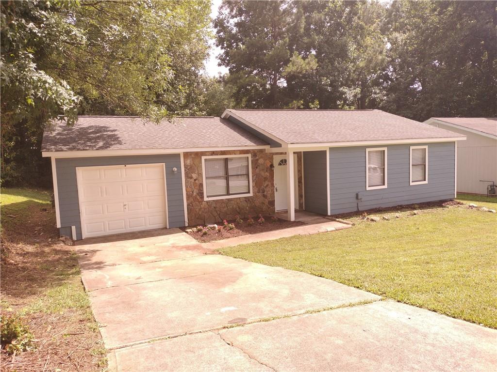4849 Plymouth Trace Decatur, GA 30035 - Photo 1 of 1 a front view of a house with a garden and garage