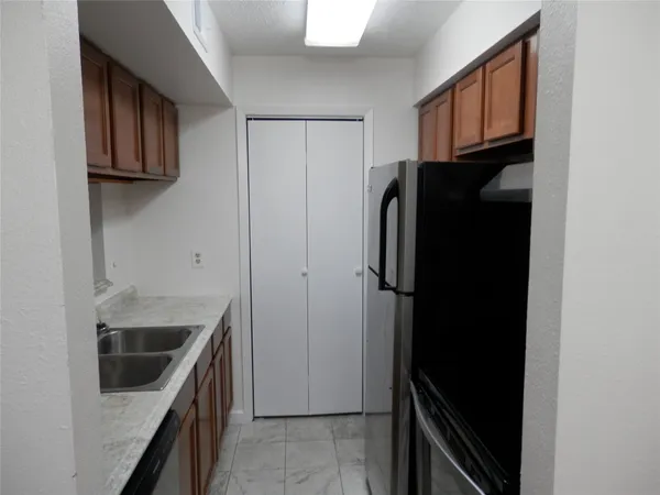 a view of empty room with wooden floor and fireplace