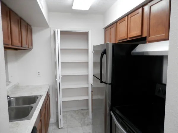a kitchen with a refrigerator and cabinets