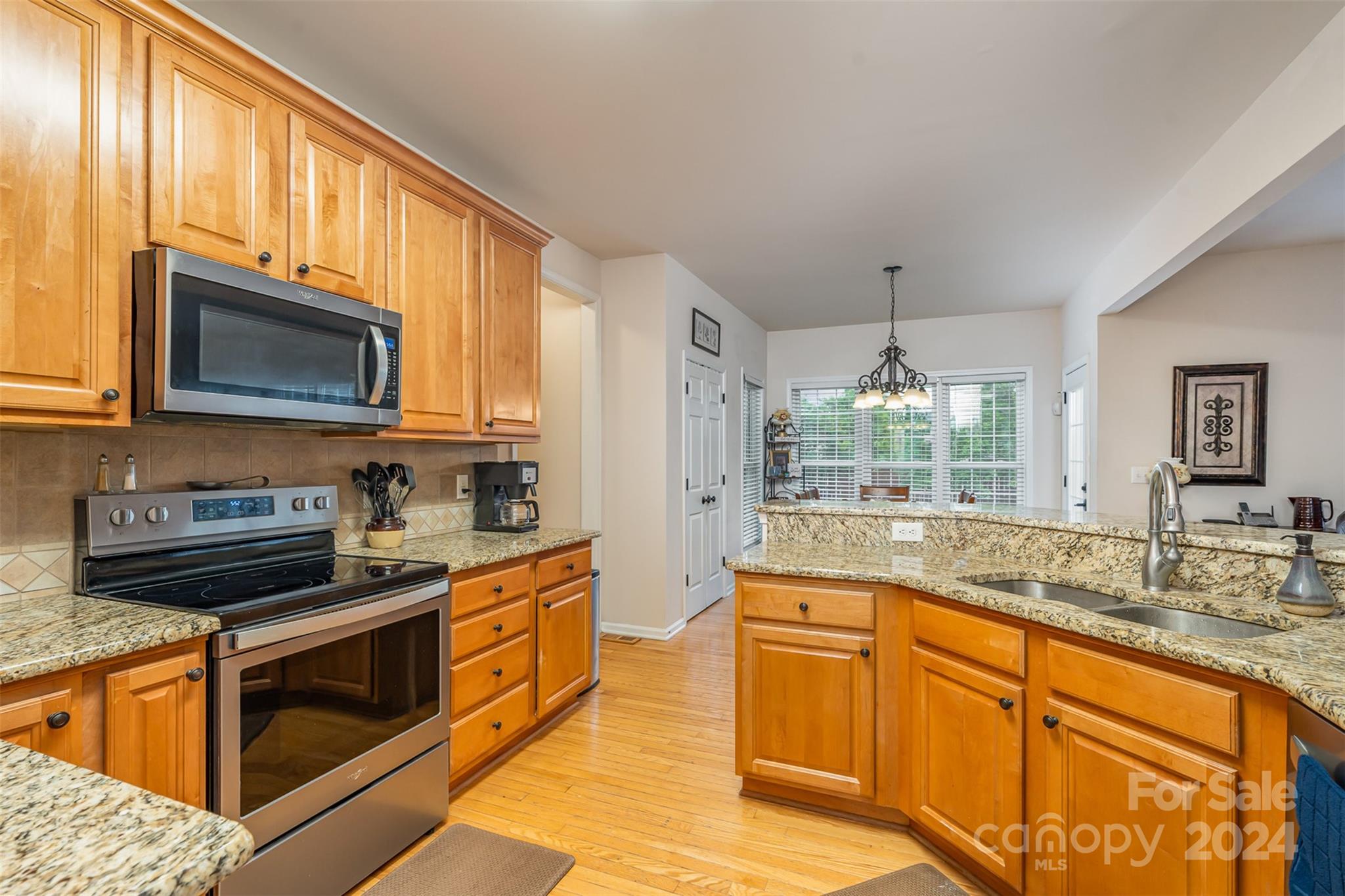 1814 Montague Road Clover, SC 29710 - Photo 14 of 33 a kitchen with stainless steel appliances granite countertop wooden cabinets a stove top oven a granite counter space and a window