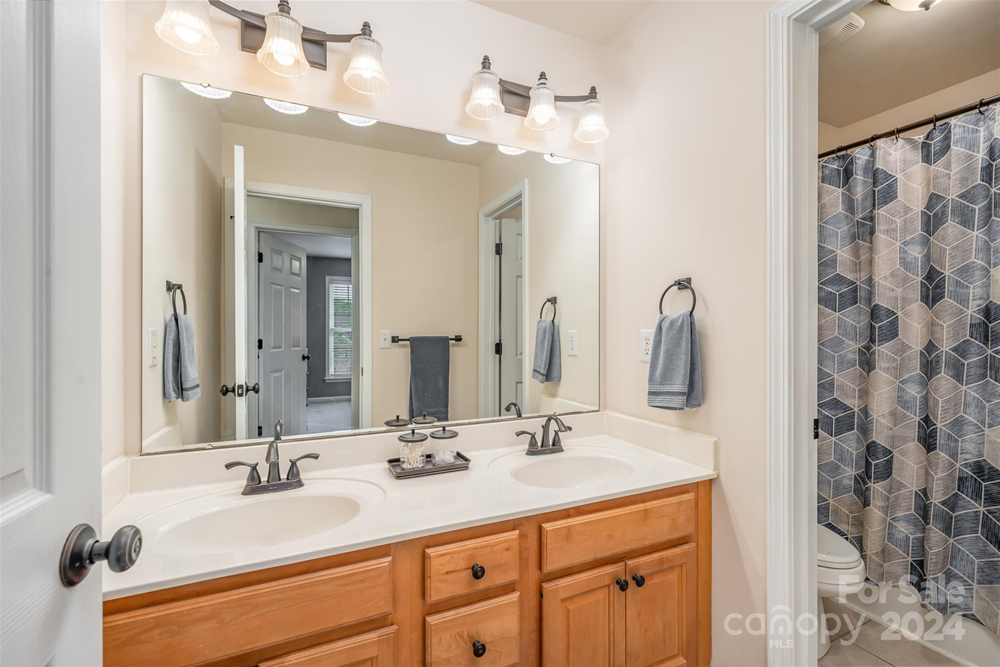1814 Montague Road Clover, SC 29710 - Photo 23 of 33 a bathroom with a double vanity sink and a mirror