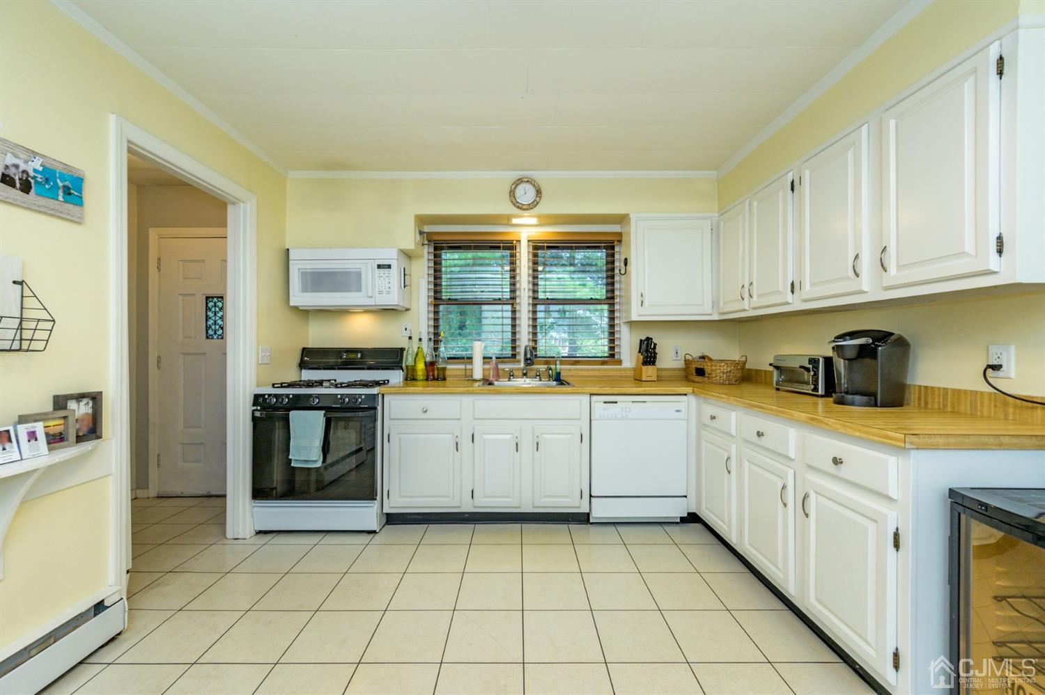 1727 River Road Belmar, NJ 07719 - Photo 14 of 38 a kitchen with a stove a sink and a refrigerator
