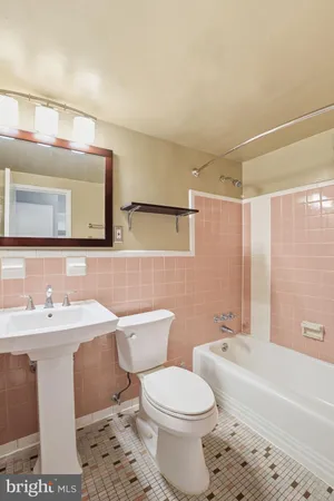 a bathroom with a sink a toilet and bathtub