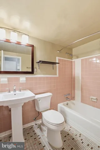 a bathroom with a sink a toilet and bathtub