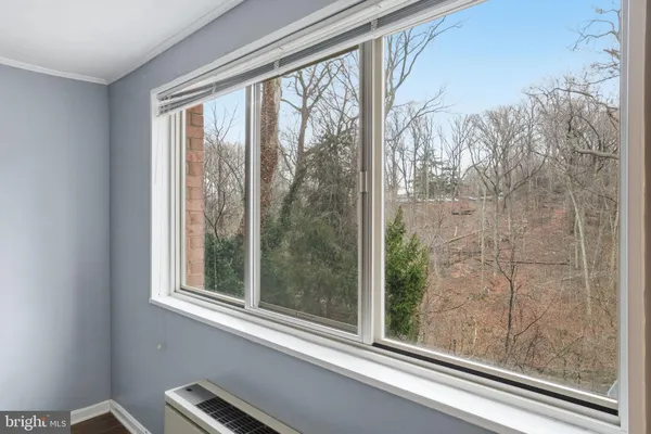 a view of a room that has window and a bed