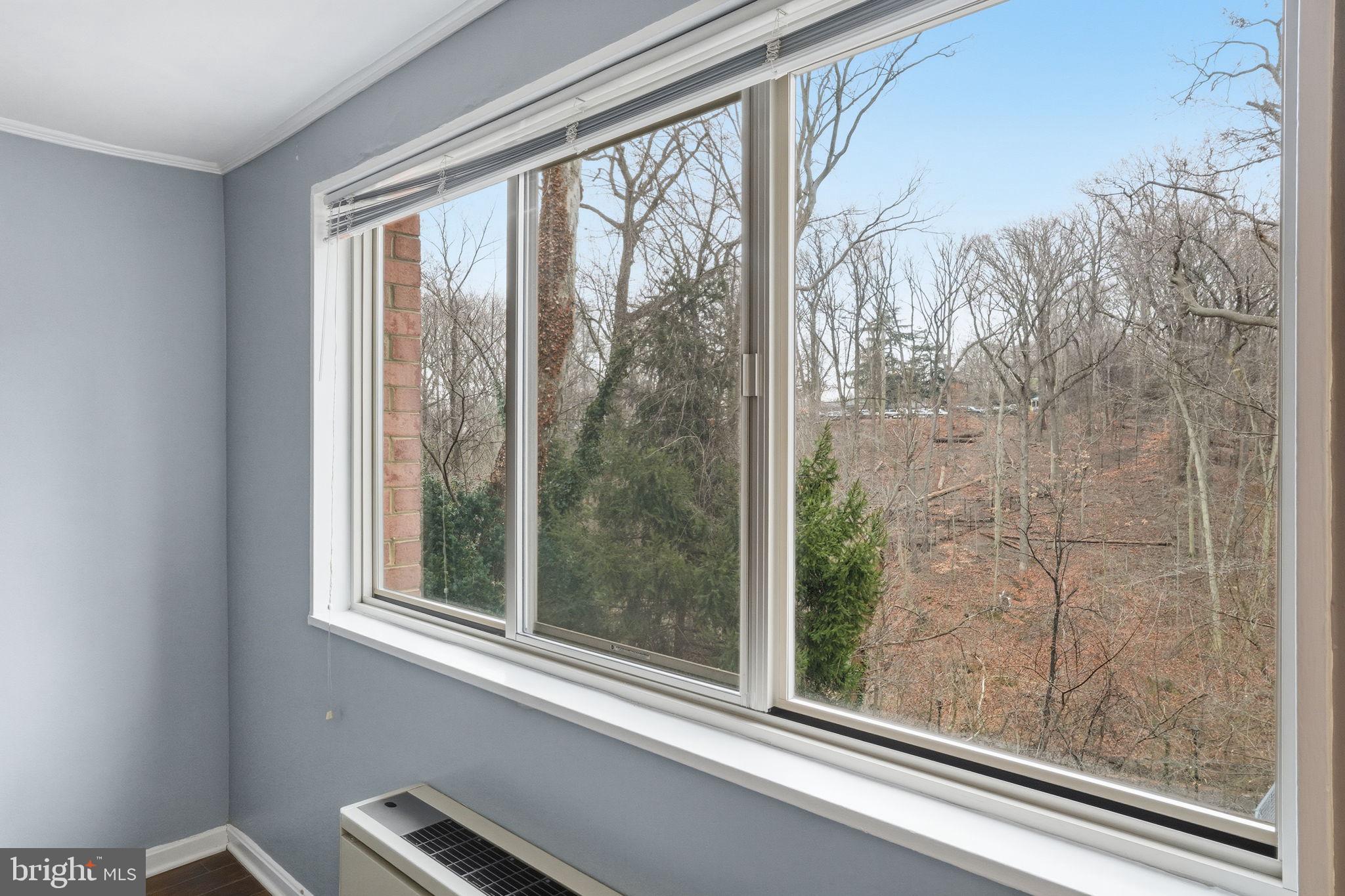 2710 Macomb Street Northwest, Unit 207 Washington, DC 20008 - Photo 8 of 32 a view of a room that has window and a bed