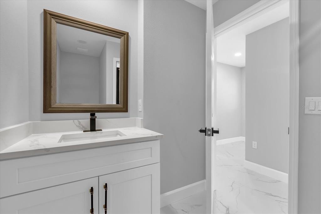 2404 Center Street Sanford, FL 32771 - Photo 15 of 29 a bathroom with a sink and a mirror