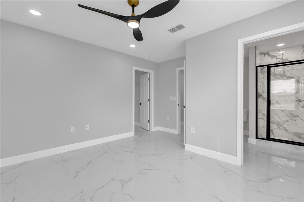 2404 Center Street Sanford, FL 32771 - Photo 17 of 29 en empty room with a ceiling fan and carpet