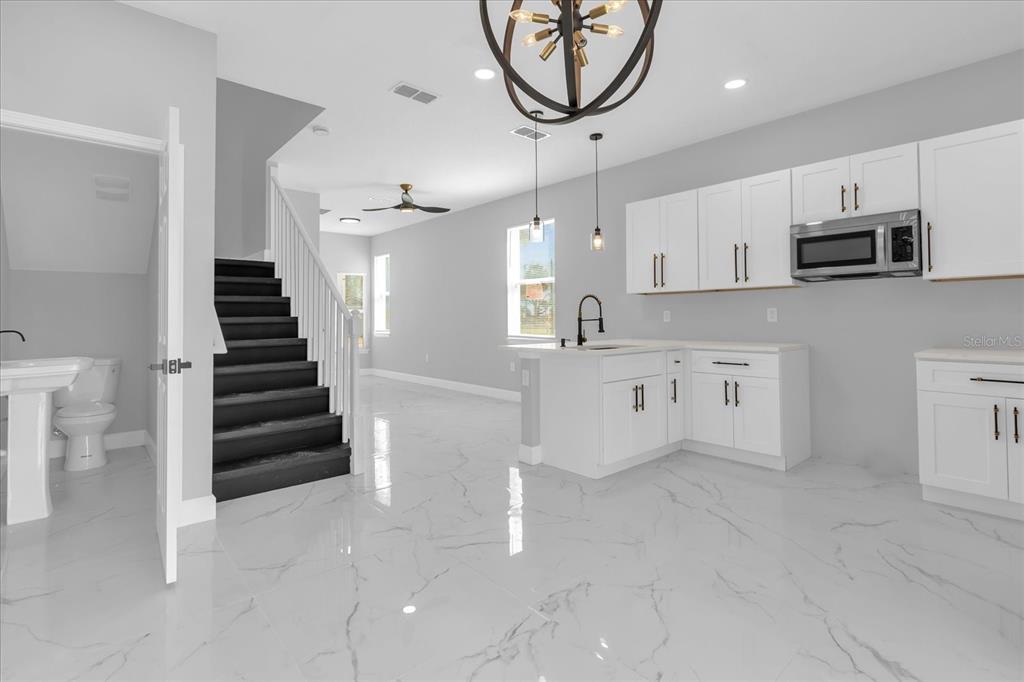 2404 Center Street Sanford, FL 32771 - Photo 3 of 29 a kitchen with stainless steel appliances cabinets a flat screen tv and a window