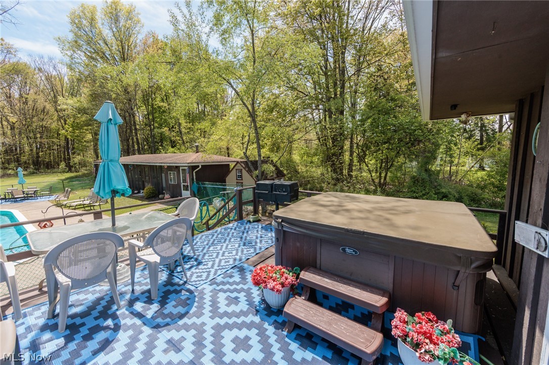 2170 Norton Road Stow, OH 44224 - Photo 8 of 48 Spacious outdoor deck with a hot tub and patterned outdoor rug