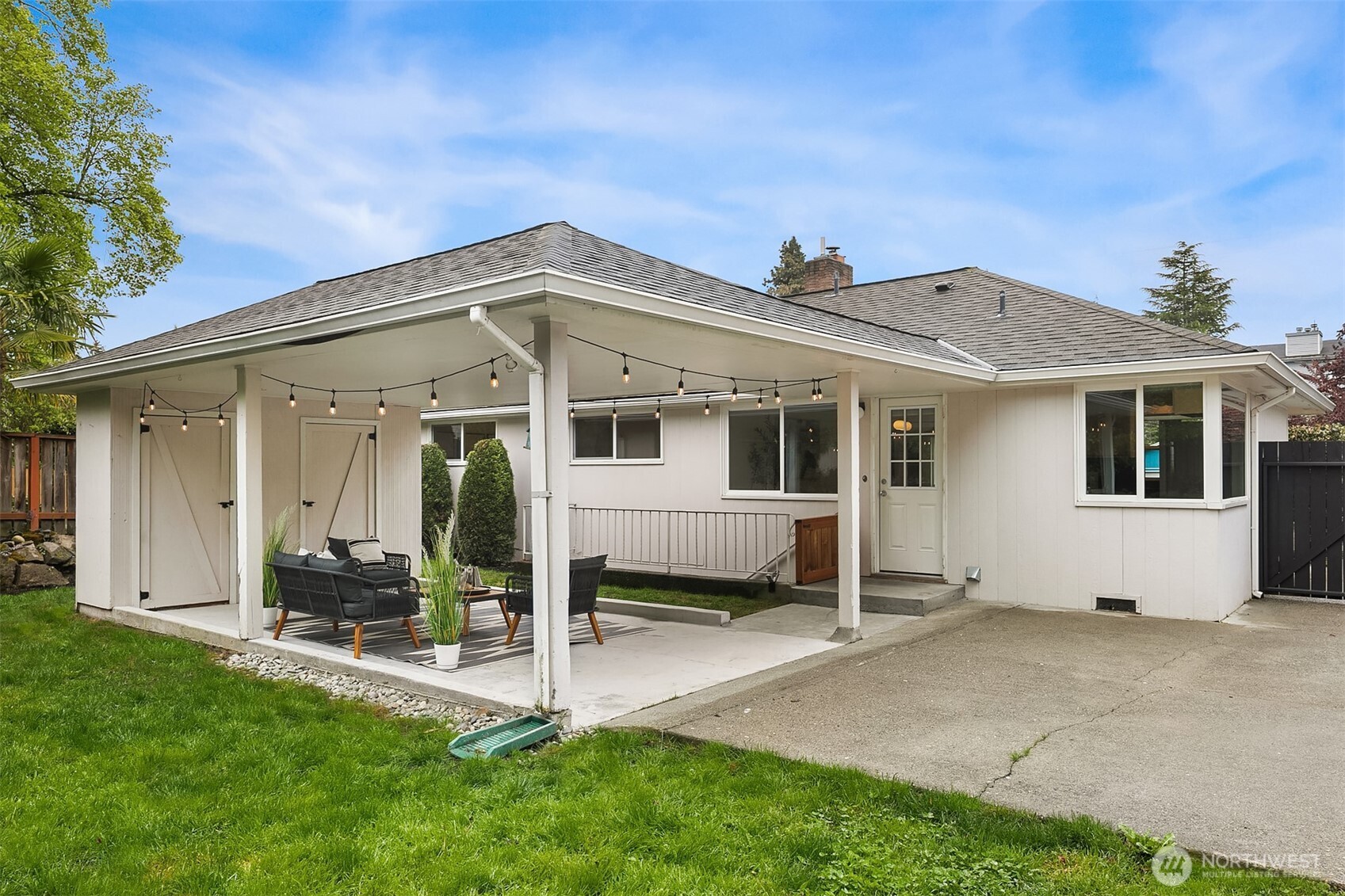 726 North 86th Street Seattle, WA 98103 - Photo 21 of 31 a view of a house with a yard and wooden fence