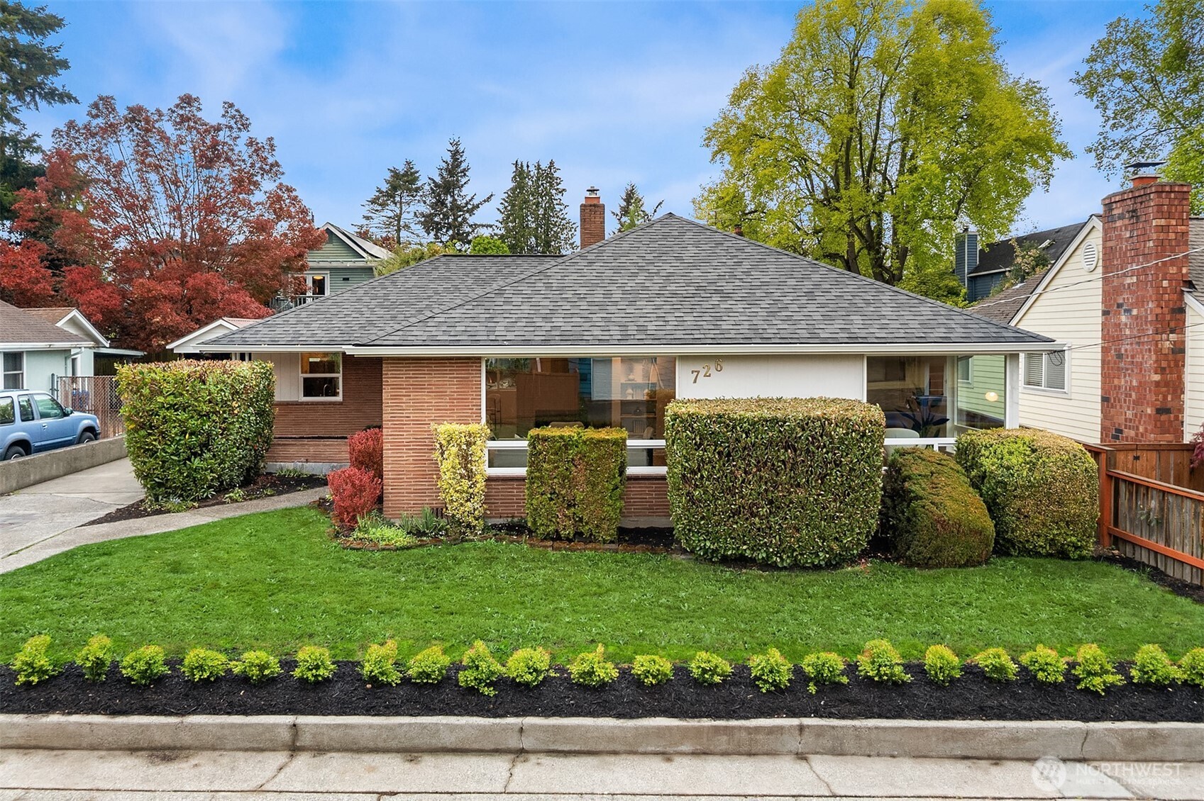 726 North 86th Street Seattle, WA 98103 - Photo 28 of 31 a view of a house with a garden and plants