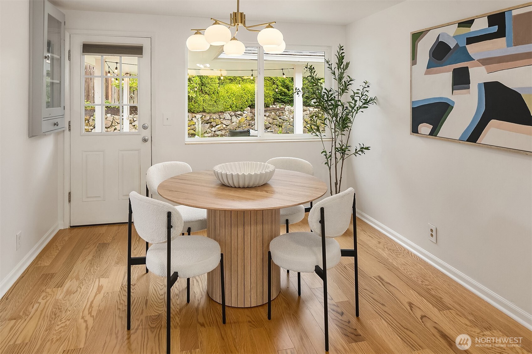726 North 86th Street Seattle, WA 98103 - Photo 7 of 31 a dining room with furniture a chandelier and wooden floor