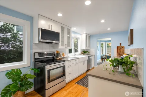 a kitchen with a sink stove and microwave