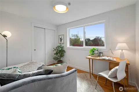 a living room with furniture and a potted plant
