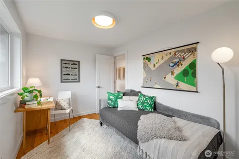 a living room with furniture and painting on the wall