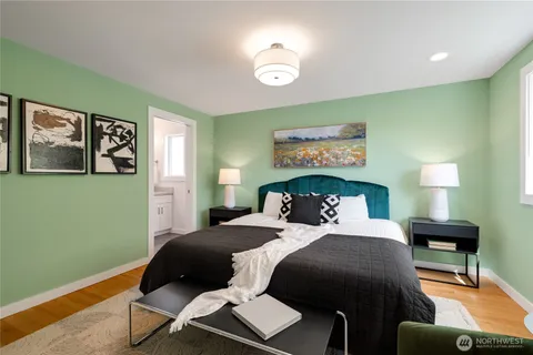a bedroom with a bed and a lamp on table