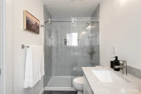 a bathroom with a sink toilet and shower