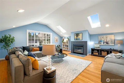 a living room with furniture a fireplace and a window