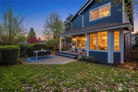 a backyard of a house with table and chairs