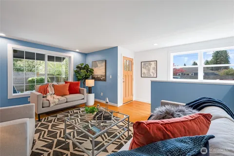 a living room with furniture and floor to ceiling windows