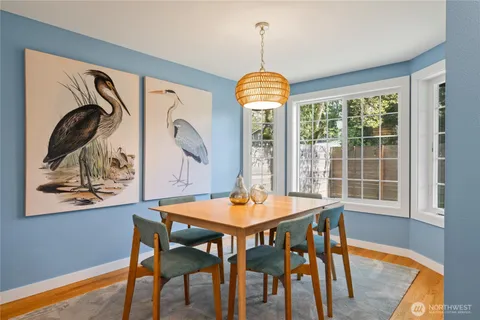 a dining room with furniture and window