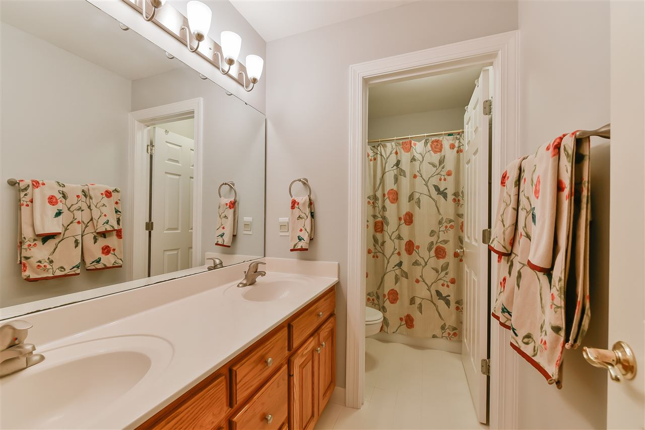 6017 Glenthorne Drive Raleigh, NC 27613 - Photo 9 of 13 Dual vanity hall bathroom has separate water closet with shower and tub. Bathroom