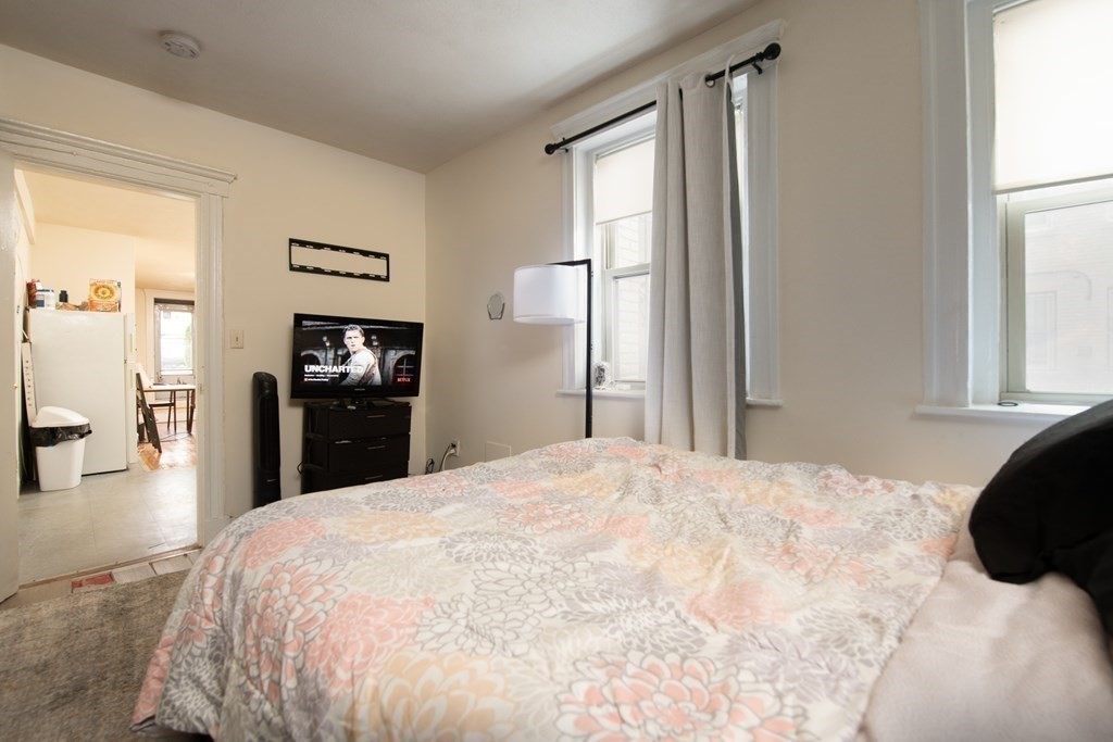 12 Ransom Road, Unit 16 Boston, MA 02135 - Photo 11 of 17 a large bedroom with bed and wooden floor